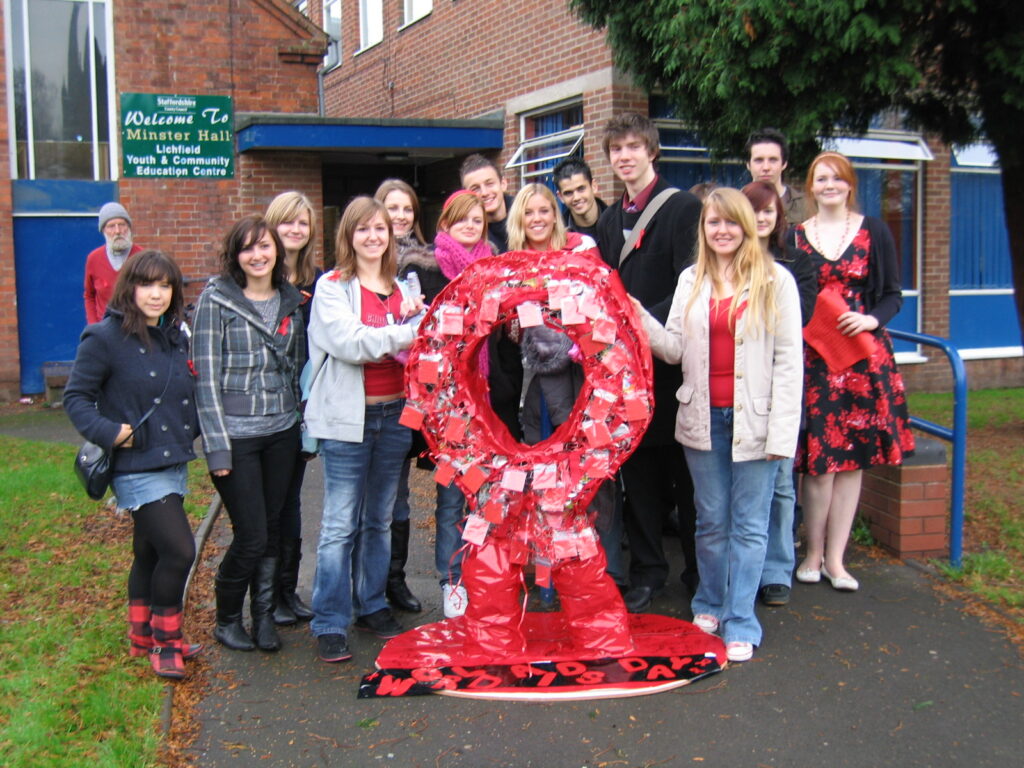 2006 -Young people at the Lichfield Youth and Community Education Centre with a huge red ribbon created to raise HIV/AIDS awareness around World AIDS Day.